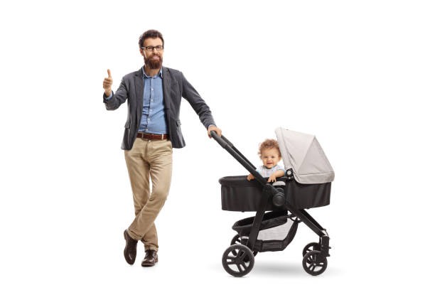 istock Father with a baby boy in a stroller holding his thumb up 1015958406