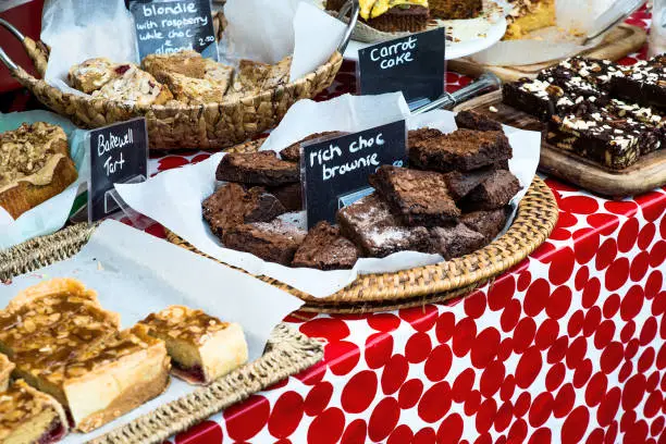 Delicious chocolate brownies and other baked products in open air market stand