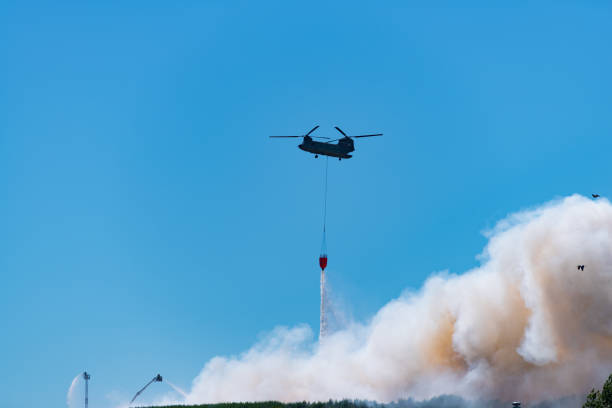 istock army chinook helicopter extinguishing a large fire 1015961176