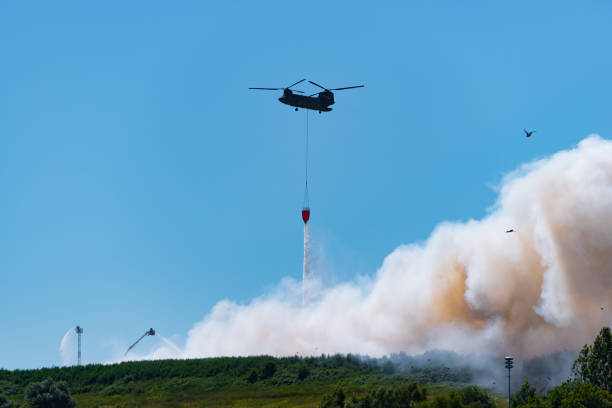 istock army chinook helicopter extinguishing a large fire 1015961454