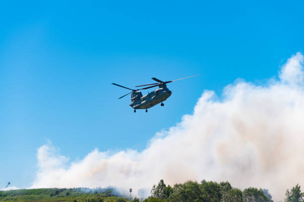 istock chinook helicopter helps extinguishing a large fire 1015961456