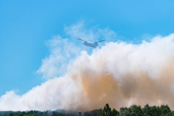 istock army chinook helicopter extinguishing a large fire 1015961954