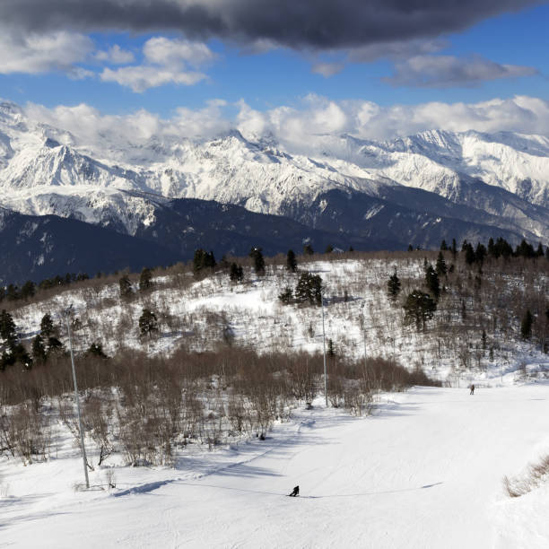 istock Skiers on ski slope at sun winter day 1015962112