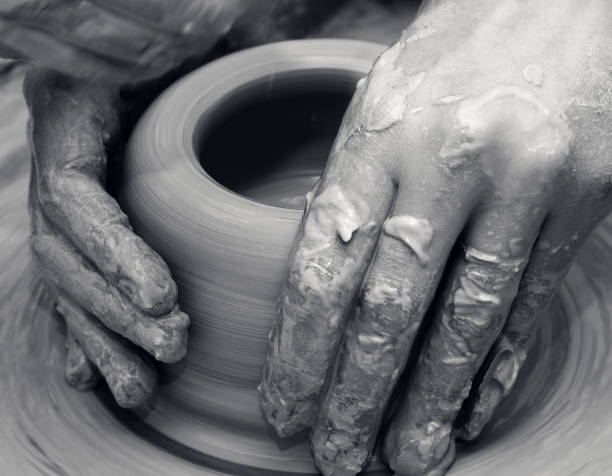 istock Women hands in process of making clay bowl on pottery wheel 1015962148
