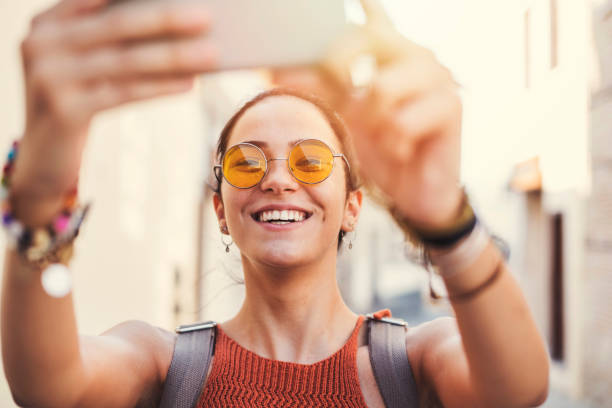 istock Beautiful young girl taking selfie 1015962398