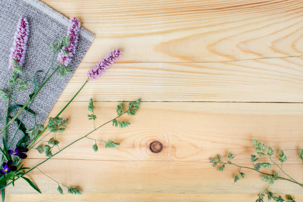 istock Small field flowers on wooden background. Copy space 1015962804
