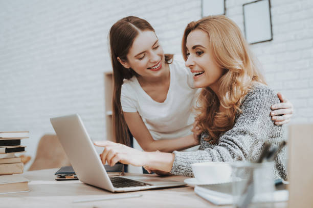 istock Mother and Daughter Watching into Laptop at Home. 1015962856