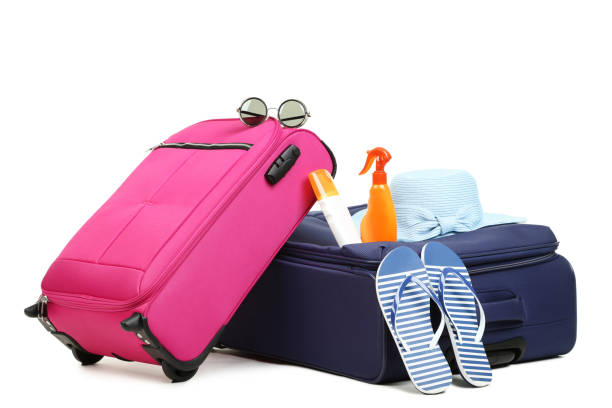 istock Suitcases with hat, flip flops and bottles isolated on white background 1015962870