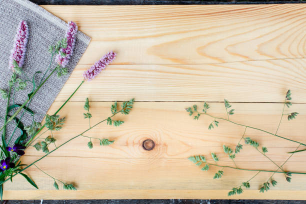 istock Small field flowers on wooden background. Copy space 1015962992