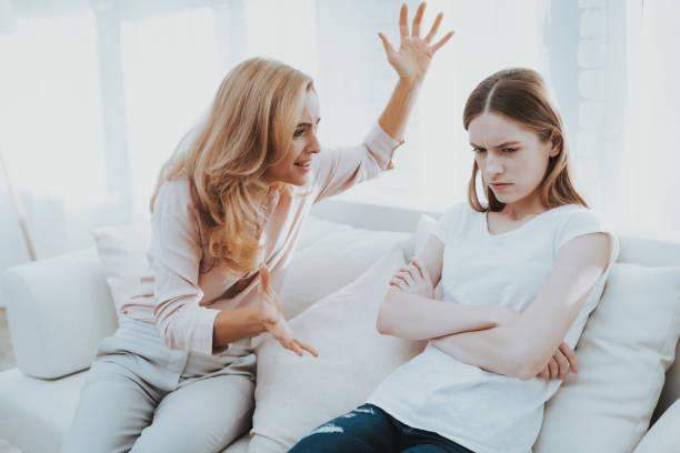 istock Quarrel between Mother and Daughter in White Room. 1015965170