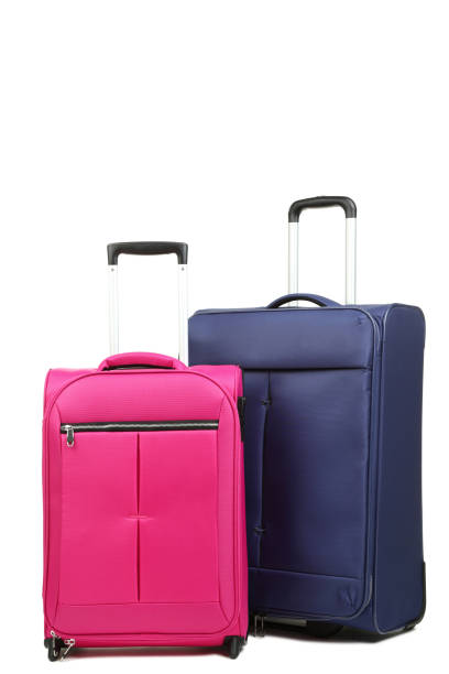 istock Blue and pink suitcases isolated on white background 1015969916