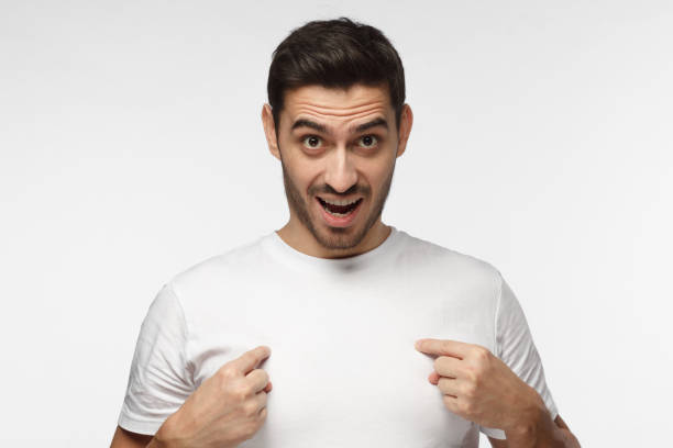 istock You talking to me? Young man pointing to himself with question if he did something wrong. 1015970258