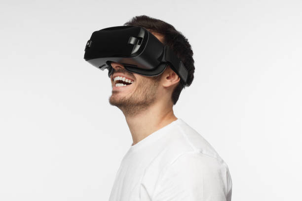 istock Portrait of young man wearing vr goggles, experiencing virtual reality using 3d headset. Technology, science, innovation and cyberspace concept. 1015970346