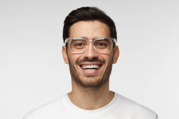 istock Joyful modern optimistic man smiles broadly, shows white perfect teeth. Positive emotions, facial expressions and happiness concept. 1015970354