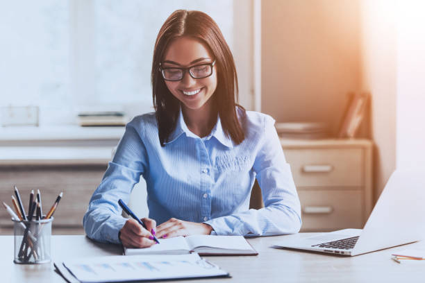 istock Smiling Young Woman Working in Modern Office. 1015987862
