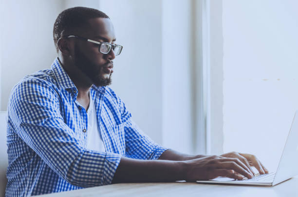 istock Young Beard Afro-american Man Working with Laptop. 1015989224
