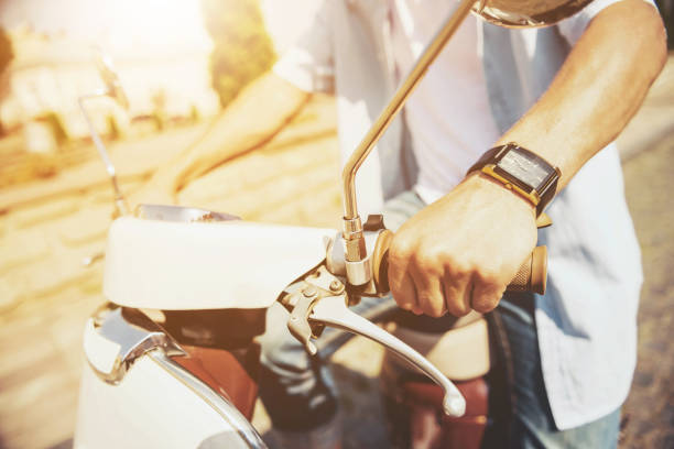 istock Close up. Young Man Sitting on Scooter Outdoors. 1015989616