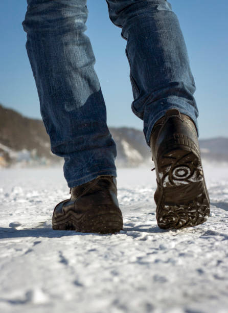 istock Men's legs view from below, winter walk, travel concept 1015994828