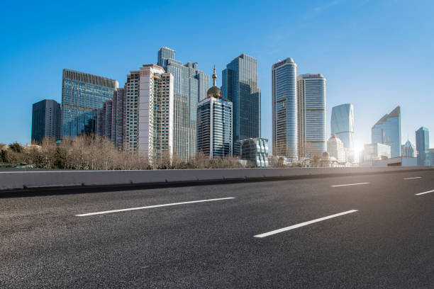 istock Qingdao modern construction commercial building office building with prospect highway asphalt pavement 1015995654