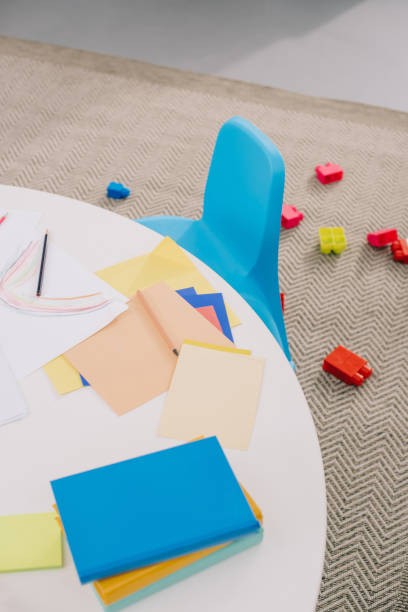 istock close up view of empty papers for drawing on table and colorful bricks on floor in classroom 1015998208