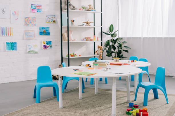 istock close up view toys, colorful bricks on floor and drawings on white wall in empty classroom 1015998548