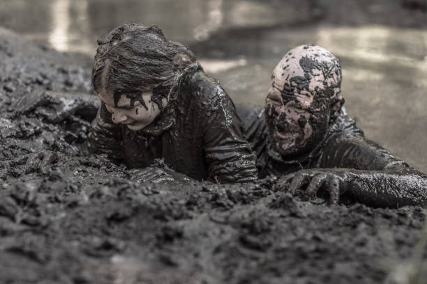 istock Father and daughter at mud run course 1015999446