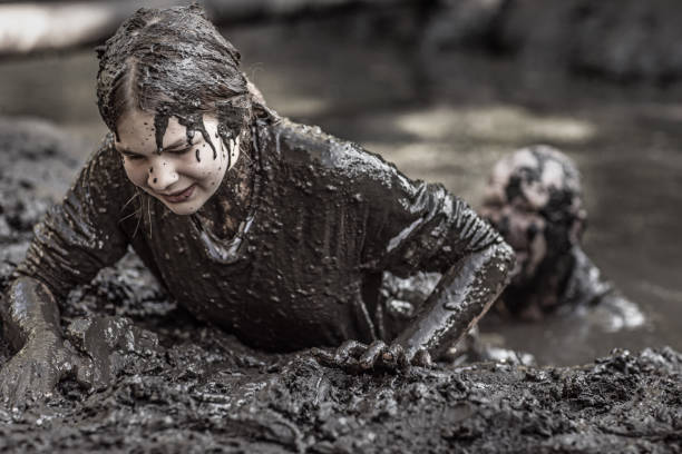 istock Father and daughter at mud run course 1015999558