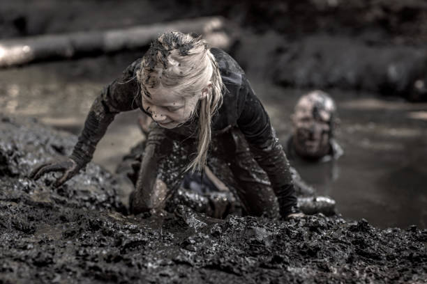 istock Father and daughter at mud run course 1016001830