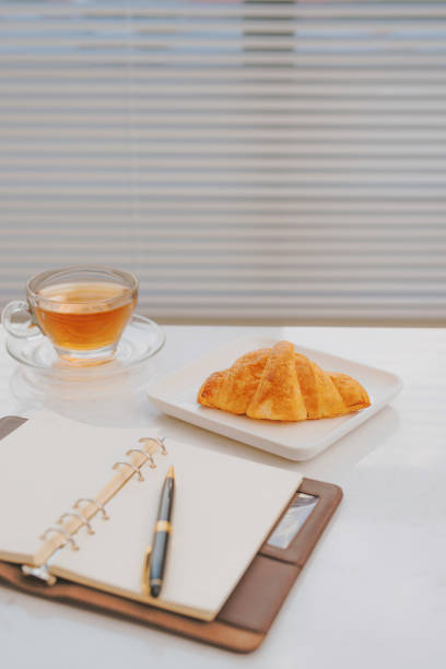 istock business work on marble table coffee with croissant bakery 1016002292