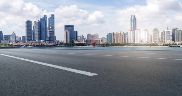 istock Qingdao modern construction commercial building office building with prospect highway asphalt pavement 1016002956