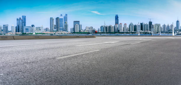 istock Qingdao modern construction commercial building office building with prospect highway asphalt pavement 1016003078