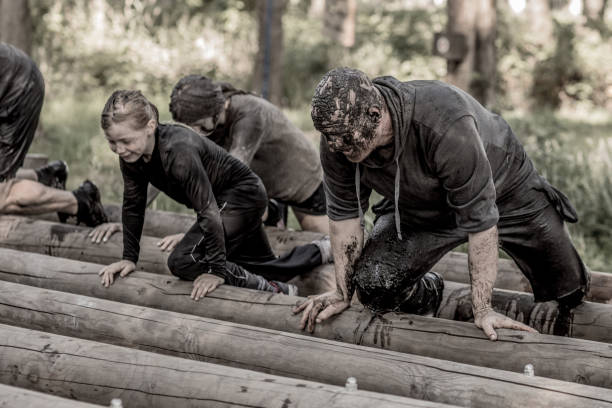 istock Father and daughter at mud run course 1016006168