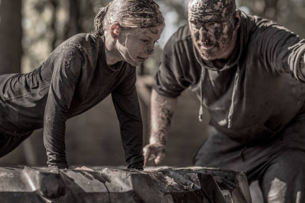istock Father and daughter at mud run course 1016006474