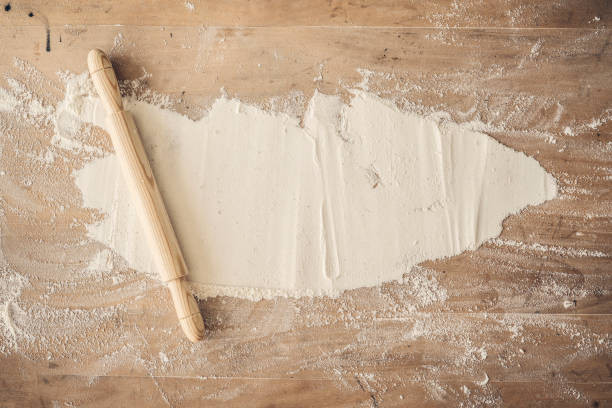 istock Rolling pin and flour on wooden table 1016013348