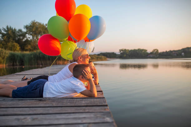 istock Playing with balloons by the lake 1016014310