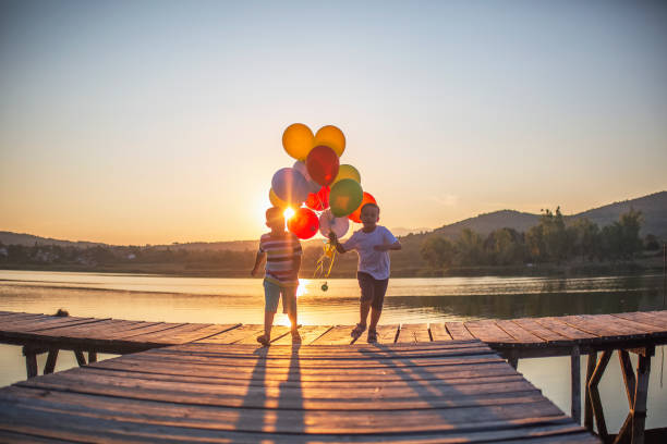 istock Playing with balloons by the lake 1016017714