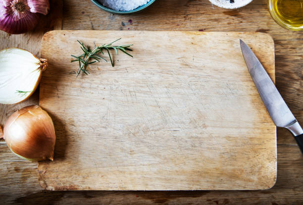 istock Cutting board and vegetables on a wooden table 1016021484