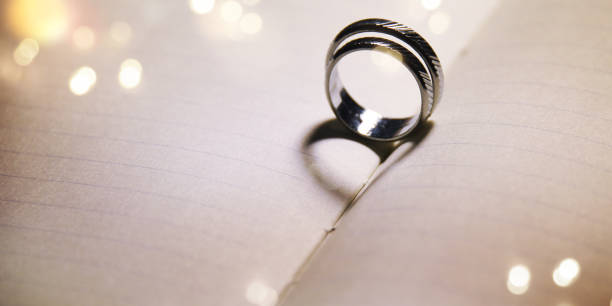 istock Wedding background with rings and heart shadow 1016023674