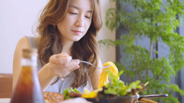 istock Asian woman eating breakfast 1016031510