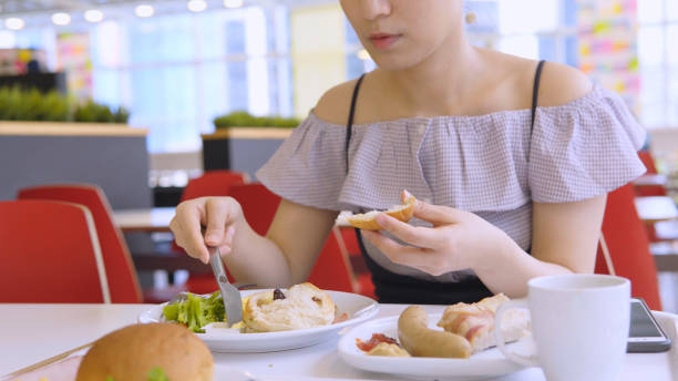 istock Asian Woman Eating Breakfast 1016031830