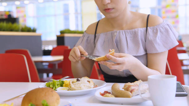 istock Asian Woman Eating Breakfast 1016031834