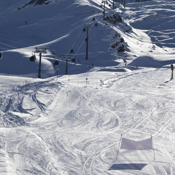 istock Ski slope and gondola lift at sun winter evening 1016035146