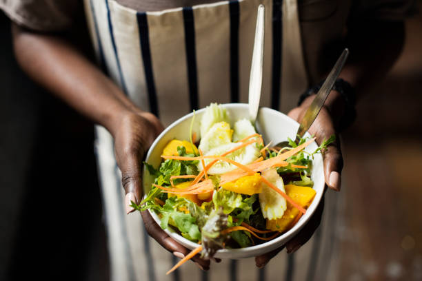 istock Black woman holding the salad bowl 1016035682