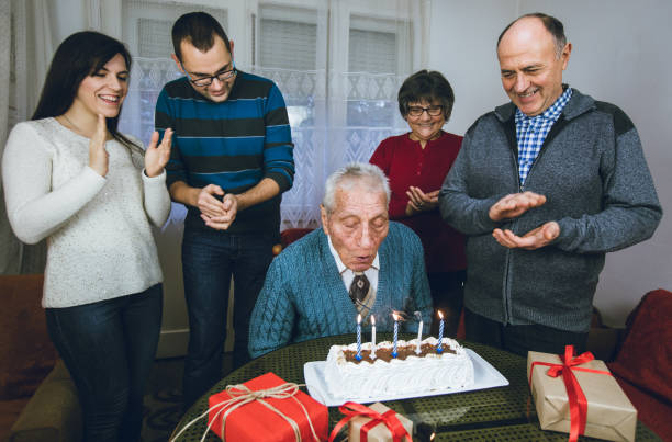 istock Elderly man celebrates birthday with family 1016038702