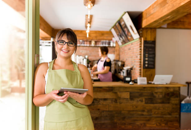 Cafe Shop Owner Cafeteria worker posing in cafe. cafe tablet stock pictures, royalty-free photos & images