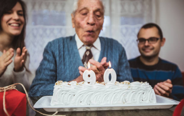 istock Elderly man celebrates birthday with family 1016039968
