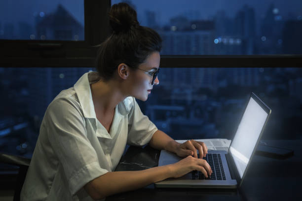 istock Woman is working with laptop at home during night. 1016042684