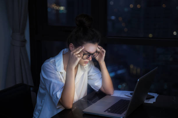 istock Woman is working with laptop at home during night. 1016042706