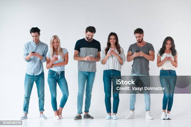 Group Of Young People On White Background Stock Photo - Download Image Now - Group Of People, Smart Phone, Friendship