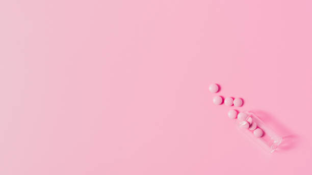 istock top view of pink medicines spilled from bottle on pink surface 1016049836